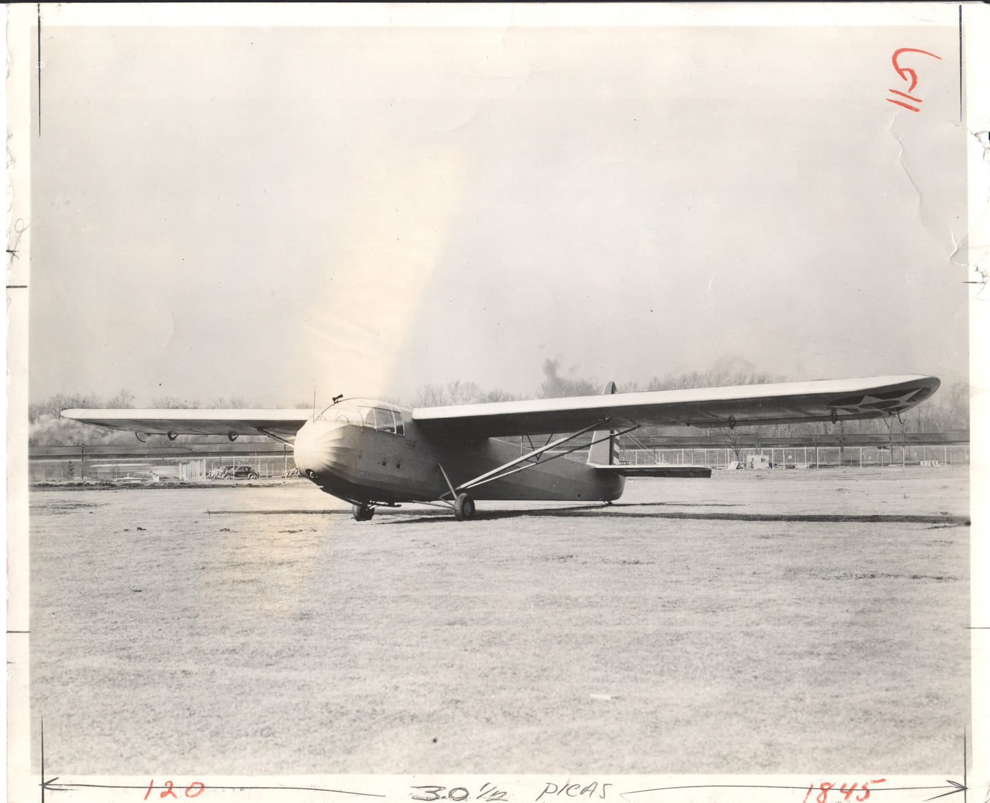 Black-and-white photograph of a vintage aircraft on a tarmac - Image: Folder20-19