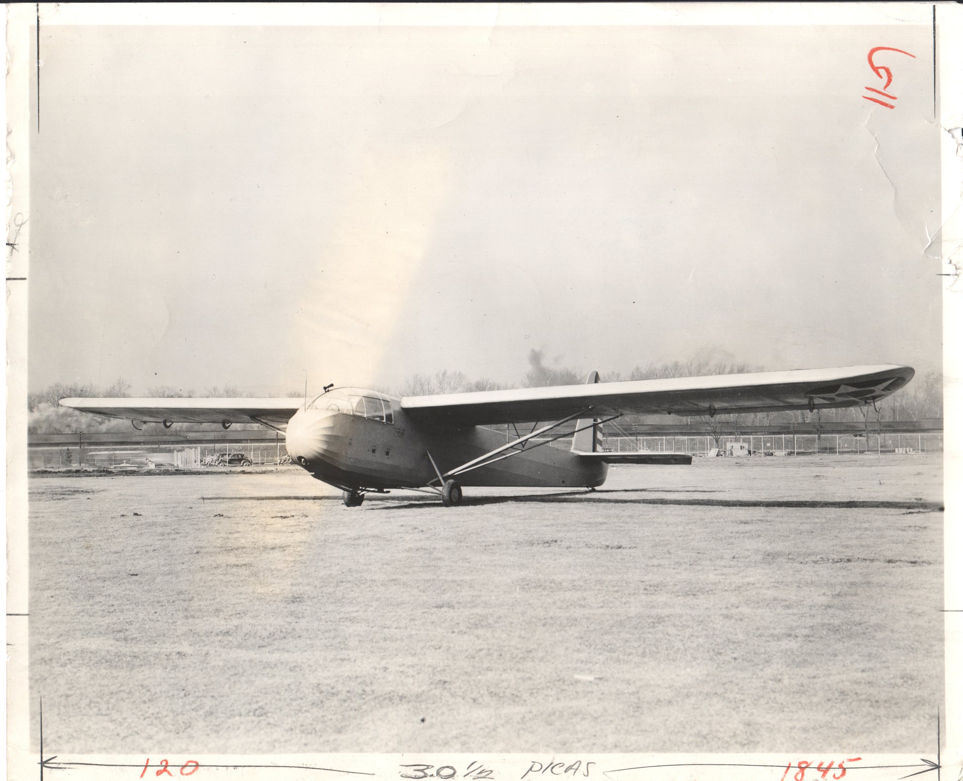 Black-and-white photograph of a vintage aircraft on a tarmac - Image: Folder20-19