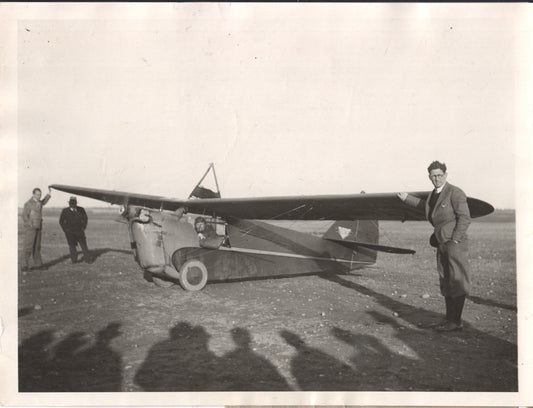 Vintage black and white photo of aviators with a biplane on an airfield. - Image: Folder20-5