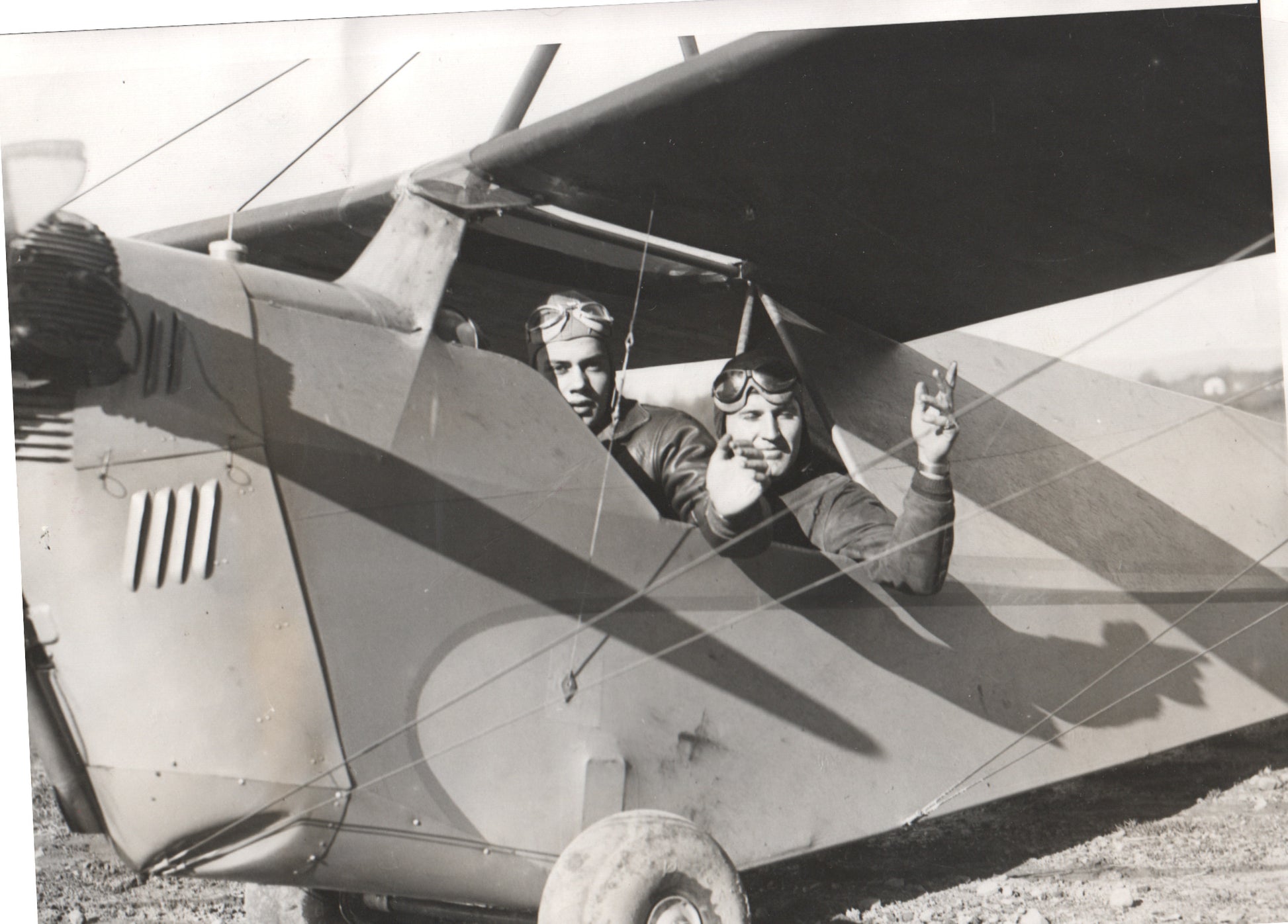 Vintage black and white photo of two aviators in a biplane. - Image: Folder3-11