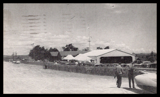 A vintage photograph of an air show featuring classic cars and people. - Image: MA-PC_0037