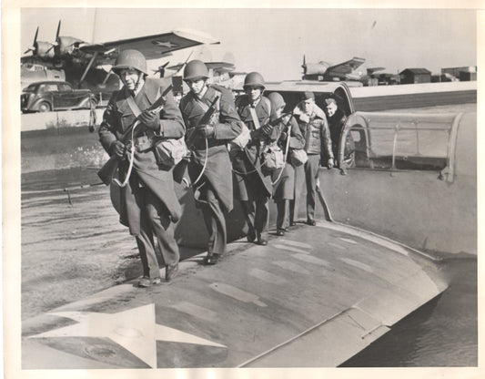 Vintage black and white photograph of soldiers boarding an aircraft during WWII. - Image: Folder17-9