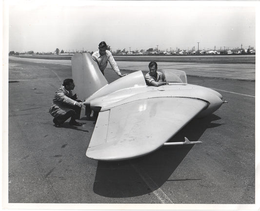 Engineers inspecting a vintage aircraft prototype on the runway. - Image: Folder26-10