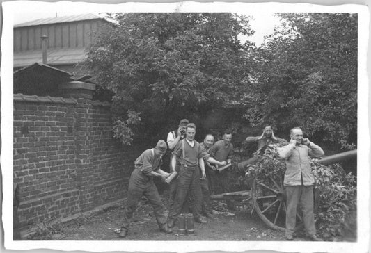 Group of men posing with artillery in a garden setting - Image: 2025-08-25-0008