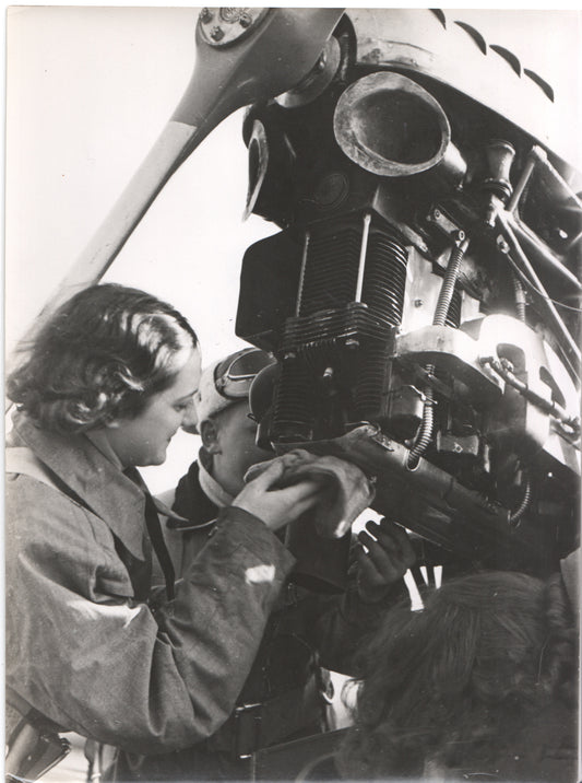 Vintage black and white photo of aviation mechanics working on an aircraft engine. - Image: Folder26-12