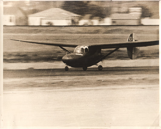 Black and white photograph of a vintage airplane taking off. - Image: Folder22-1