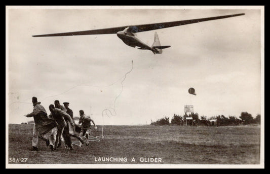 Vintage postcard depicting the launching of a glider with people running below. - Image: MA-PC_0051