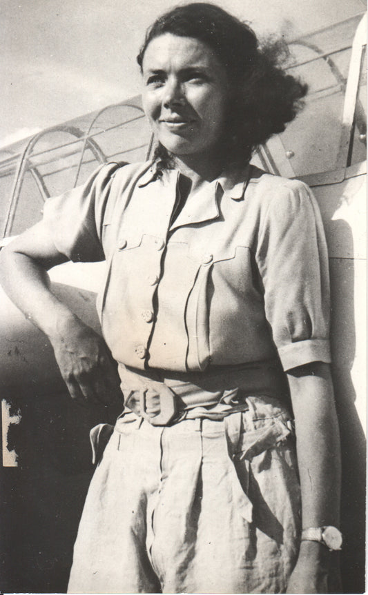 Vintage photo of a female aviator standing beside an aircraft. - Image: Folder8-4