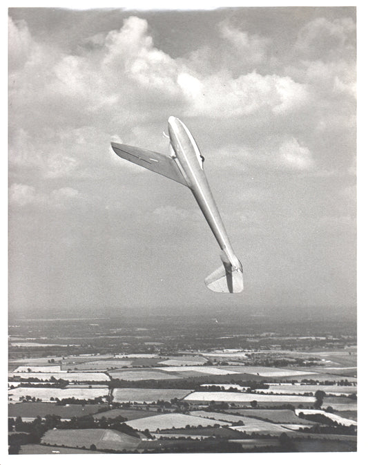 A vintage black and white photo of a glider flying against a cloudy sky. - Image: Folder3-13