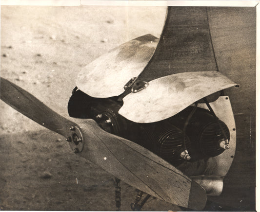 Vintage aviation engine propeller assembly displayed on a textured background - Image: Folder26-5