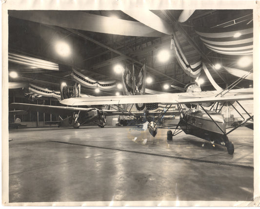 Vintage photograph of airplanes in a decorated hangar. - Image: Folder28-27
