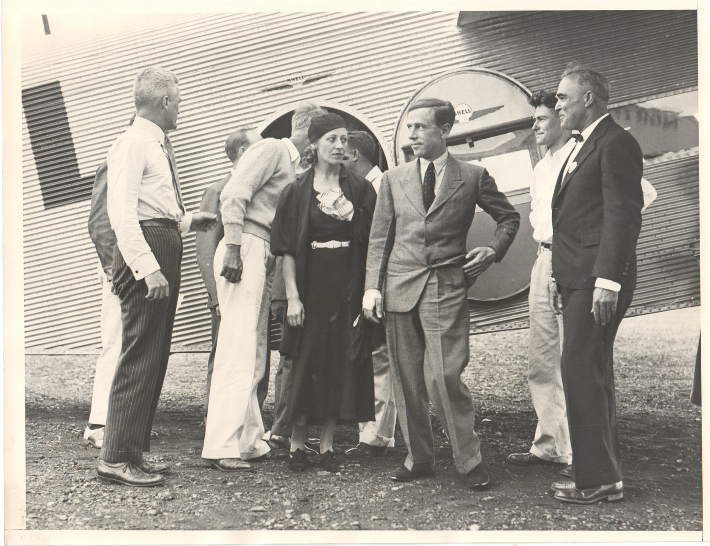 Historical photograph of people gathered near an early aircraft. - Image: Folder18-3