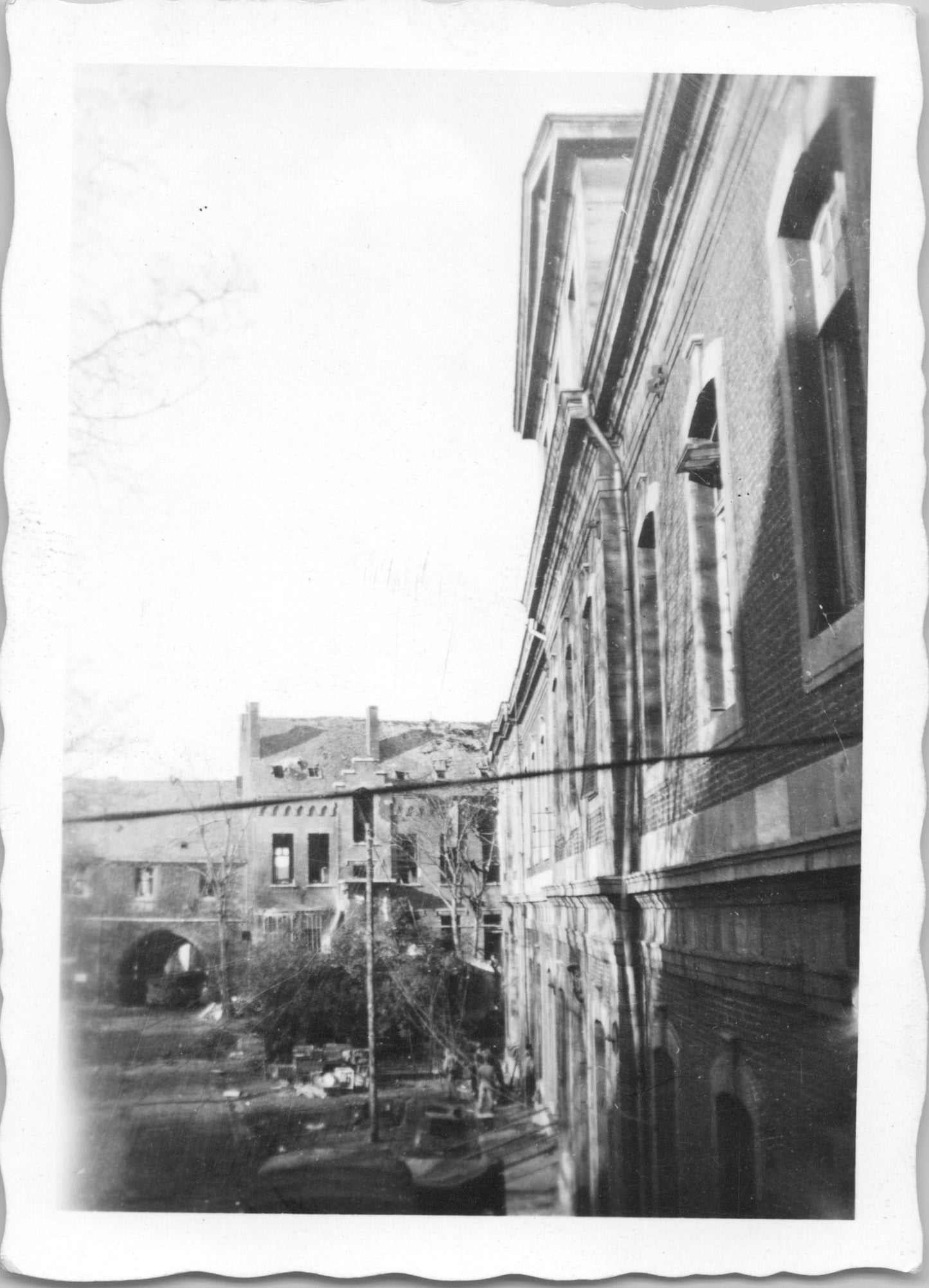 Black and white photograph of a vintage building with surrounding ruins. - Image: 2025-08-25-0002