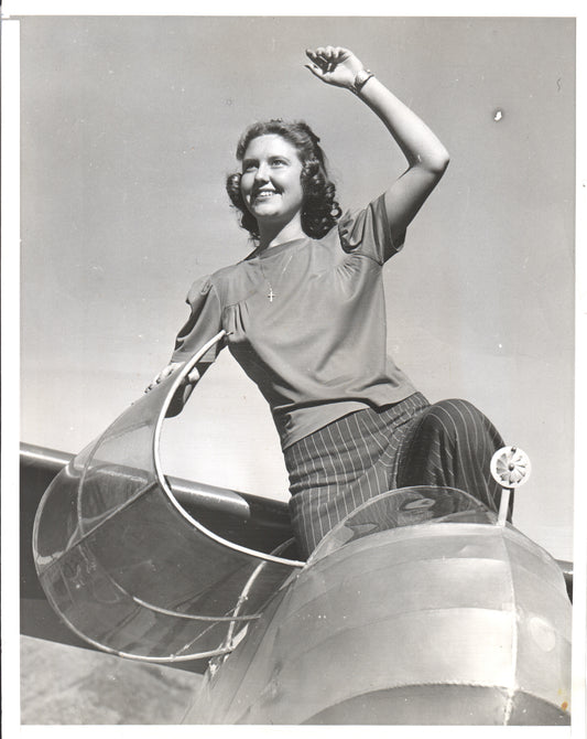 Black and white photo of a smiling woman on an aircraft wing - Image: Folder23-6