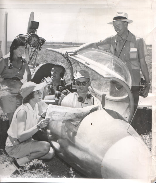 Vintage black and white photograph of a group in and around a glider cockpit. - Image: Folder25-21